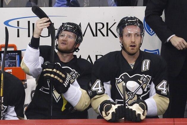 Pittsburgh Penguins' Brooks Orpik (44) and Paul Martin, left, sit  on the bench during the third period of an NHL hockey game between the Pittsburgh Penguins and the Florida Panthers in Pittsburgh, Monday, Jan. 20, 2014. (AP Photo/Gene J. Puskar)