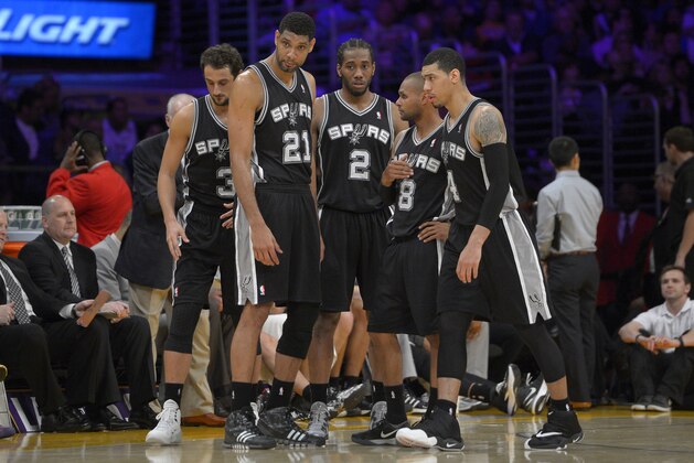 San Antonio Spurs, from left, Marco Belinelli, of Italy, Tim Duncan, Kawhi Leonard, Patty Mills, of Australia, and Danny Green wait during a timeout in the second half of their NBA basketball game, Wednesday, March 19, 2014, in Los Angeles. The Spurs won 125-109. (AP Photo/Mark J. Terrill)