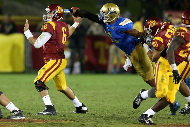 LOS ANGELES, CA - NOVEMBER 30:  Linebacker Anthony Barr #11 of the UCLA Bruins strips the ball  from quarterback Cody Kessler #36 of the USC Trojans for a fumble and a turnover in the fourth quarter at Los Angeles Coliseum on November 30, 2013 in Los Angeles, California.  The Bruins won 35-14.  (Photo by Stephen Dunn/Getty Images)