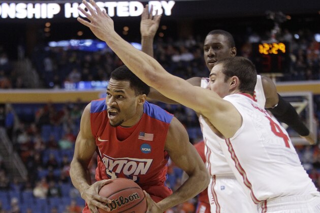 Dayton's Vee Sanford (43) drives past Ohio State's Aaron Craft (4) during the first half of a second-round game in the NCAA college basketball tournament Thursday, March 20, 2014, in Buffalo, N.Y.  (AP Photo/Bill Wippert)