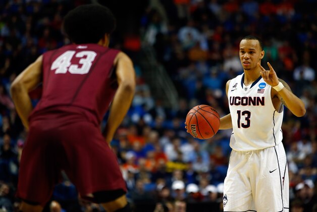 BUFFALO, NY - MARCH 20: Shabazz Napier #13 of the Connecticut Huskies calls a play against the Saint Joseph's Hawks during the second round of the 2014 NCAA Men's Basketball Tournament at the First Niagara Center on March 20, 2014 in Buffalo, New York.  (Photo by Jared Wickerham/Getty Images)