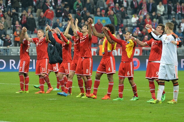 Bayern's players celebrate with supporters after the Champions League round of the last 16 second leg soccer match between FC Bayern Munich and Arsenal FC in Munich, Germany, on Tuesday, March 11. 2014. The match finished 1:1. (AP Photo/Kerstin Joensson)