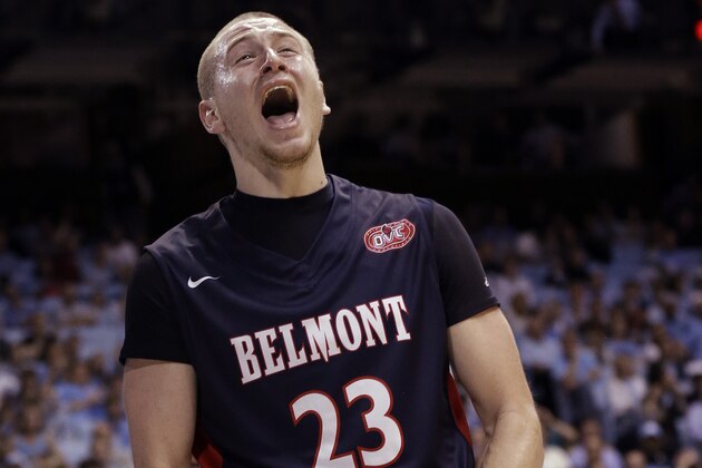 Belmont's Craig Bradshaw (23) reacts following a basket against North Carolina during the second half of an NCAA college basketball game in Chapel Hill, N.C., Sunday, Nov. 17, 2013. Belmont won 83-80. North Carolina's James Michael McAdoo walks away at rear. (AP Photo/Gerry Broome)