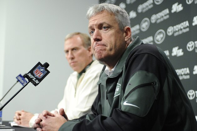 New York Jets coach Rex Ryan, right, reacts as he and general manager John Idzik speak to the media  during an NFL football news conference Tuesday, Dec. 31, 2013, in Florham Park, N.J. (AP Photo/Bill Kostroun)