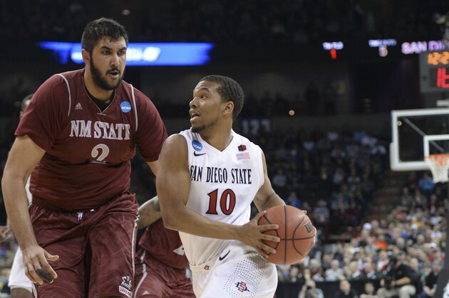 Mar 20, 2014; Spokane, WA, USA; San Diego State Aztecs guard Aqeel Quinn (10) drives to the basket against New Mexico State Aggies center Sim Bhullar (2) in the first half of a men's college basketball game during the second round of the 2014 NCAA Tournament at Veterans Memorial Arena. Mandatory Credit: Kirby Lee-USA TODAY Sports