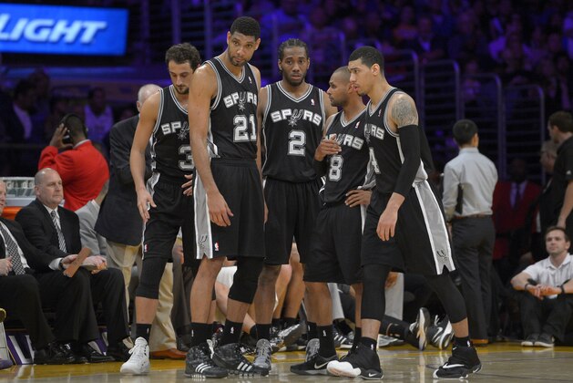 San Antonio Spurs, from left, Marco Belinelli, of Italy, Tim Duncan, Kawhi Leonard, Patty Mills, of Australia, and Danny Green wait during a timeout in the second half of their NBA basketball game, Wednesday, March 19, 2014, in Los Angeles. The Spurs won 125-109. (AP Photo/Mark J. Terrill)