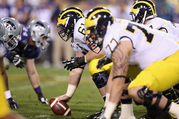 TEMPE, AZ - DECEMBER 28:  offensive linesman Graham Glasgow #61 of the Michigan Wolverines prepares to snap the football during the Buffalo Wild Wings Bowl against the Kansas State Wildcats at Sun Devil Stadium on December 28, 2013 in Tempe, Arizona.  The Wildcats defeated the Wolverines 31-14.  (Photo by Christian Petersen/Getty Images)