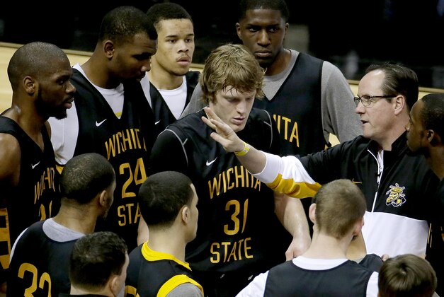 Wichita State coach Gregg Marshall, right, talks to his players during practice for the NCAA college basketball tournament Thursday, March 20, 2014, in St. Louis. Wichita State is scheduled to play against Cal Poly in a second-round game on Friday. (AP Photo/Charlie Riedel)