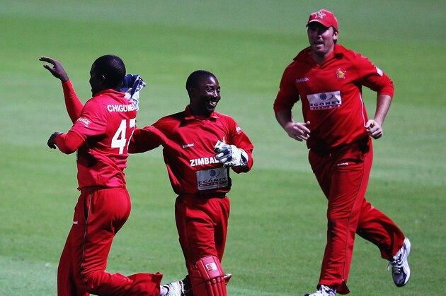 HAMILTON, NEW ZEALAND - FEBRUARY 14:  Tatenda Taibu celebrates with Elton Chigumbura of Zimbabwe after the dismissal of Nathan McCullum of New Zealand  during the second International Twenty20 match between New Zealand and Zimbabawe at Seddon Park on February 14, 2012 in Hamilton, New Zealand.  (Photo by Hannah Peters/Getty Images)