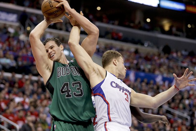 Boston Celtics forward Kris Humphries, left, pulls a rebound away from Los Angeles Clippers forward Blake Griffin during the second half of an NBA basketball game in Los Angeles, Wednesday, Jan. 8, 2014. (AP Photo/Chris Carlson)