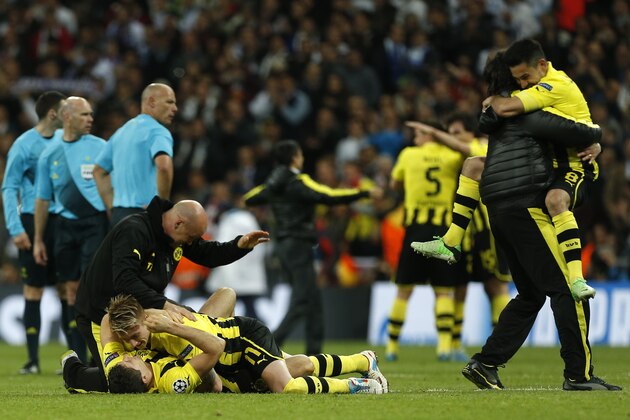 Dortmund players celebrate advancing to the final after the Champions League semifinal second leg soccer match between Real Madrid and Borussia Dortmund at the Santiago Bernabeu stadium in Madrid, Spain, Tuesday, April 30, 2013. (AP Photo/Andres Kudacki)