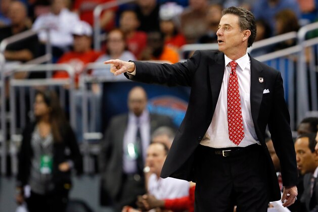 ORLANDO, FL - MARCH 20:  Head coach Rick Pitino of the Louisville Cardinals spoints on court against the Manhattan Jaspers during the second round of the 2014 NCAA Men's Basketball Tournament at Amway Center on March 20, 2014 in Orlando, Florida.  (Photo by Kevin C. Cox/Getty Images)