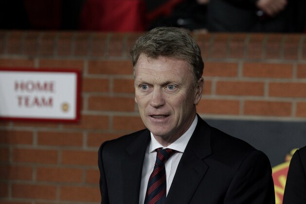 Manchester United's manager David Moyes arrives pitch side before the start of their Champions League last 16 second leg soccer match against Olympiakos at Old Trafford Stadium, Manchester, England, Wednesday, March 19, 2014. (AP Photo/Jon Super)