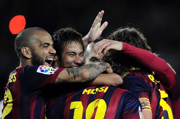 FC Barcelona's Daniel Alves, from Brazil, left, and Neymar, from Brazil, second left, celebrate a goal against Almeria during a Spanish La Liga soccer match at the Camp Nou stadium in Barcelona, Spain, Sunday, March 2, 2014. (AP Photo/Manu Fernandez)