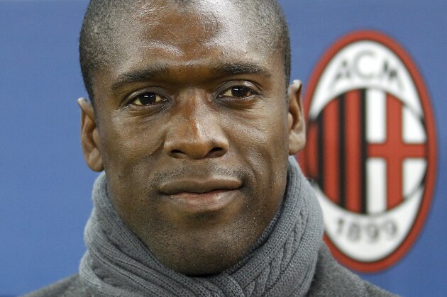 AC Milan coach Clarence Seedorf waits for the start of a Champions League, round of 16, second leg, soccer match between Atletico Madrid and AC Milan at the Vicente Calderon stadium in Madrid, Tuesday March 11, 2014. (AP Photo/Paul White)