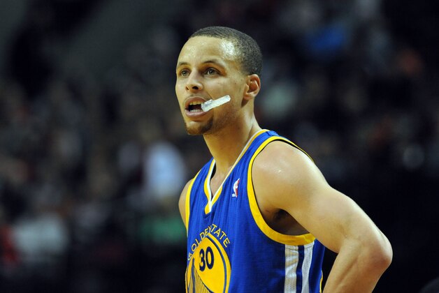 Mar 16, 2014; Portland, OR, USA; Golden State Warriors guard Stephen Curry (30) looks on as a Portland Trail Blazer shoots a free throw during the fourth quarter of the game at the Moda Center. The Warriors won the game 113-112. Mandatory Credit: Steve Dykes-USA TODAY Sports