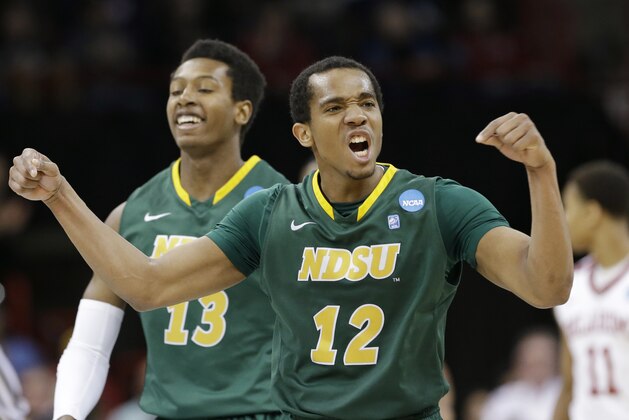 North Dakota State's Lawrence Alexander (12) celebrates in overtime during a second-round game against Oklahoma in the NCAA men's college basketball tournament in Spokane, Wash., Thursday, March 20, 2014. North Dakota State won 80-75. (AP Photo/Elaine Thompson)