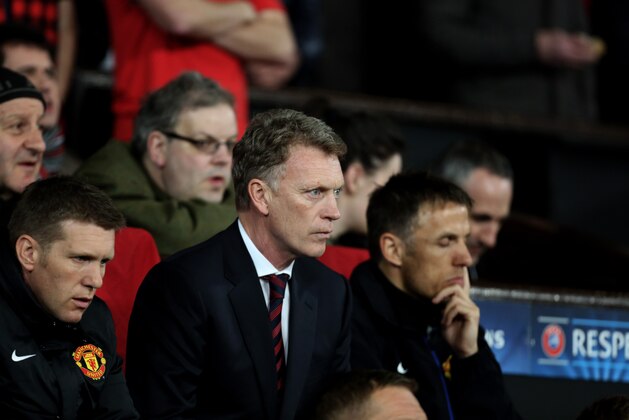 Manchester United's manager David Moyes, center, waits for the start of their Champions League last 16 second leg soccer match against Olympiakos at Old Trafford Stadium, Manchester, England, Wednesday, March 19, 2014. (AP Photo/Jon Super)