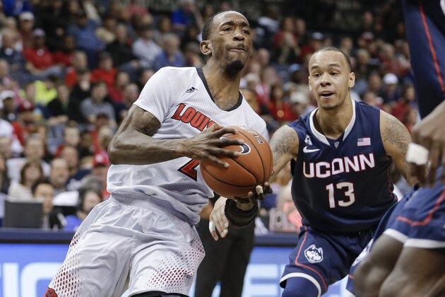 Louisville guard Russ Smith (2) drives past Connecticut guard Shabazz Napier (13) during the first half of an NCAA college basketball game in the finals of the American Athletic Conference men's tournament Saturday, March 15, 2014, in Memphis, Tenn. (AP Photo/Mark Humphrey)