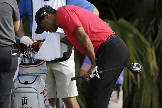 Tiger Woods wipes his face before teeing off on the 12th hole during the final round of the Cadillac Championship golf tournament Sunday, March 9, 2014, in Doral, Fla. (AP Photo/Lynne Sladky)