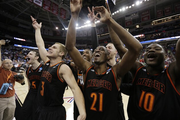 Mercer guard Langston Hall (21) and other Mercer players celebrate after the second half of an NCAA college basketball second-round game against Duke, Friday, March 21, 2014, in Raleigh, N.C. Mercer won 78-71. (AP Photo/Chuck Burton)