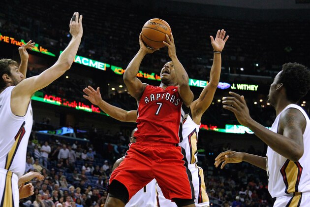 Toronto Raptors guard Kyle Lowry (7) drives to the basket against New Orleans Pelicans center Jeff Withey, left, and New Orleans Pelicans forward Al-Farouq Aminu, right, during the first half of an NBA basketball game in New Orleans, Wednesday, March 19, 2014. The Raptors won 107-100. (AP Photo/Jonathan Bachman)