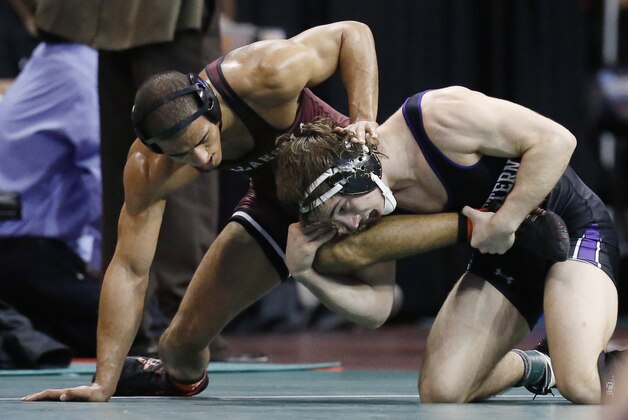 Oklahoma's Kendric Maple, left, wrestles Northwestern's Jason Tsirtsis, right, in a 149-pound match in the quarterfinals of the NCAA Division I wrestling championships in Oklahoma City, Friday, March 21, 2014. (AP Photo/Sue Ogrocki)