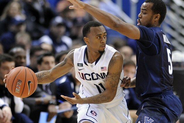 Connecticut's Ryan Boatright, left, is guarded by Villanova's Tony Chennault during the first half of an NCAA college basketball game in Hartford, Conn., Saturday, Feb. 16, 2013. (AP Photo/Fred Beckham)
