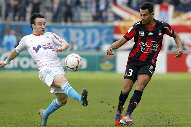 Marseille's French midfielder Mathieu Valbuena, left,  challenges for the ball with Nice's French defender Timothee Kolodziejczak , during their League One soccer match, in Marseille, southern France, Sunday, Nov. 11, 2012. (AP Photo/Claude Paris)
