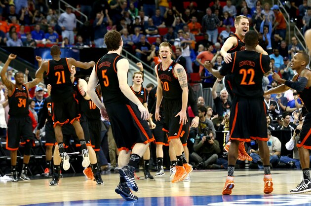 RALEIGH, NC - MARCH 21:  Jakob Gollon #20 of the Mercer Bears celebrates with teammates after defeating the Duke Blue Devils 78-71 during the Second Round of the 2014 NCAA Basketball Tournament at PNC Arena on March 21, 2014 in Raleigh, North Carolina.  (Photo by Streeter Lecka/Getty Images)