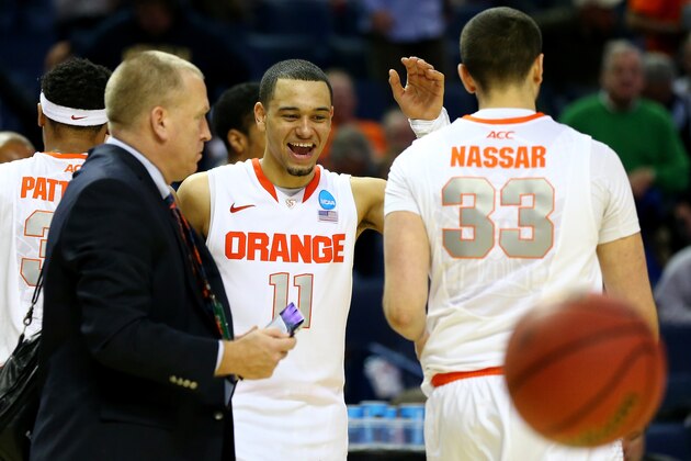 BUFFALO, NY - MARCH 20: Tyler Ennis #11 celebrates with Albert Nassar #33 of the Syracuse Orange after defeating the Western Michigan Broncos 77-53 during the second round of the 2014 NCAA Men's Basketball Tournament at the First Niagara Center on March 20, 2014 in Buffalo, New York.  (Photo by Elsa/Getty Images)
