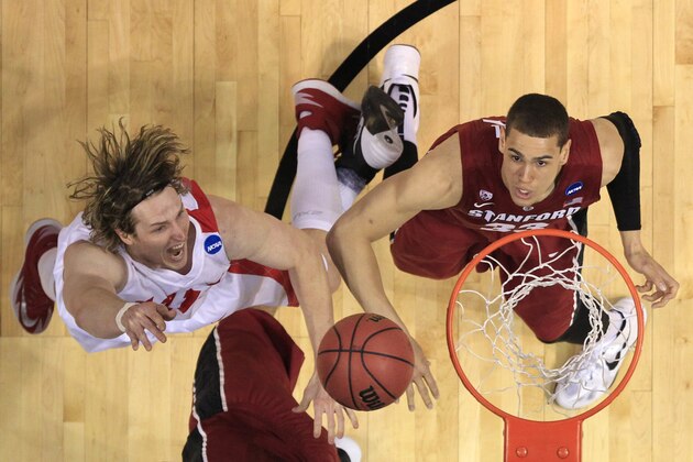 New Mexico's Cameron Bairstow, left, heads to the basket as Stanford's Dwight Powell watches during the first half of a second-round game in the NCAA college basketball tournament Friday, March 21, 2014, in St. Louis. (AP Photo/Jeff Roberson)