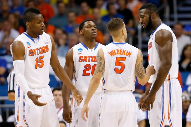ORLANDO, FL - MARCH 20:  (L-R) Will Yeguete #15, Michael Frazier II #20, Scottie Wilbekin #5 and Patric Young #4 of the Florida Gators talk in the second half against the Albany Great Danes during the second round of the 2014 NCAA Men's Basketball Tournament at Amway Center on March 20, 2014 in Orlando, Florida.  (Photo by Kevin C. Cox/Getty Images)