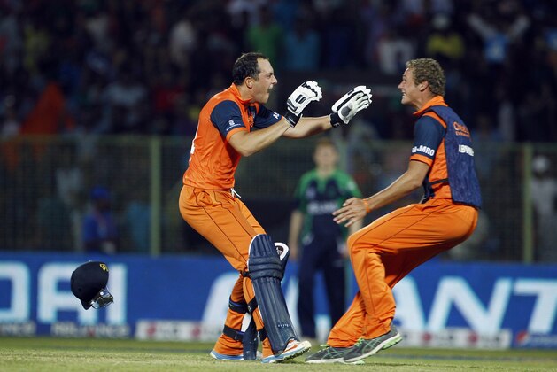 Netherlands' Wesley Barresi, left, celebrates with teammate after winning the ICC Twenty20 Cricket World Cup match against Ireland in Sylhet, Bangladesh, Friday, March 21, 2014. (AP Photo/A.M. Ahad)