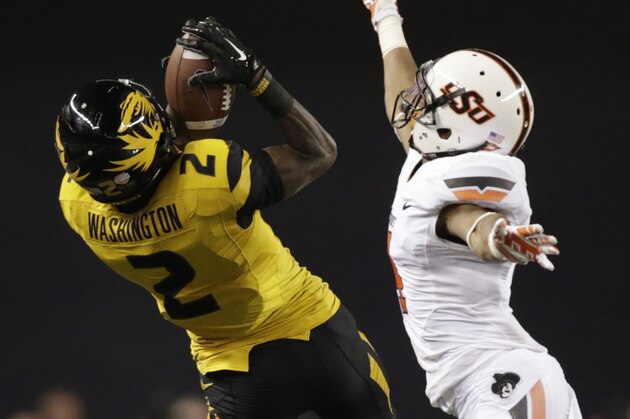 Jan 3, 2014; Arlington, TX, USA;Missouri Tigers wide receiver L'Damian Washington (2) catches a pass while defended by  Oklahoma State Cowboys cornerback Justin Gilbert (4) in the fourth quarter of the game  at the 2014 Cotton Bowl at AT&T Stadium. Missouri beat Oklahoma State 41-31. Mandatory Credit: Tim Heitman-USA TODAY Sports
