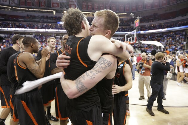 Mercer'sJakob Gollon, right, and Bud Thomas embrace after defeating Duke 78-71 in an NCAA college basketball second-round game against Duke, Friday, March 21, 2014, in Raleigh, N.C.  (AP Photo/Chuck Burton)