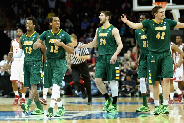 SPOKANE, WA - MARCH 20:  Lawrence Alexander #12 of the North Dakota State Bison celebrates with teammate during the game against the Oklahoma Sooners in the second round of the 2014 NCAA Men's Basketball Tournament at Spokane Veterans Memorial Arena on March 20, 2014 in Spokane, Washington.  North Dakota State won the game 80-75.  (Photo by Stephen Dunn/Getty Images)