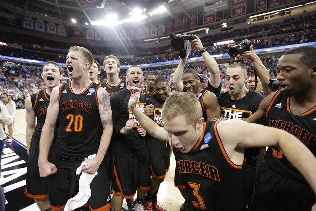 Mercer team members celebrate after the second half of an NCAA college basketball second-round game against Duke, Friday, March 21, 2014, in Raleigh, N.C. Mercer won 78-71. (AP Photo/Chuck Burton)