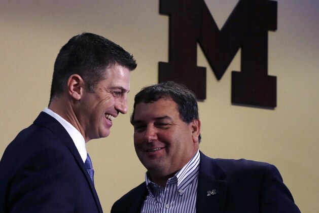 Doug Nussmeier, left, stands with head coach Brady Hoke after being introduced as Michigan's NCAAA college football offensive coordinator and quarterbacks coach during a news conference at the Junge Center in Ann Arbor, Mich., Friday, Jan. 10, 2014. Nussmeier is the former Alabama offensive coordinator. (AP Photo/Carlos Osorio)