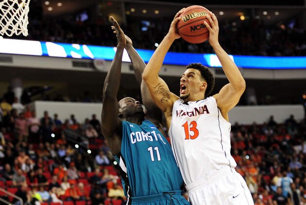 RALEIGH, NC - MARCH 21:  Anthony Gill #13 of the Virginia Cavaliers goes up against El Hadji Ndieguene #11 of the Coastal Carolina Chanticleers in the first half during the Second Round of the 2014 NCAA Basketball Tournament at PNC Arena on March 21, 2014 in Raleigh, North Carolina.  (Photo by Grant Halverson/Getty Images)