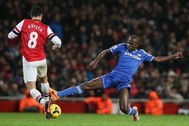 Arsenal's Mikel Arteta, left is tackled by Chelsea's Ramires during their English Premier League soccer match between Arsenal and Chelsea at the Emirates stadium in London, Monday, Dec. 23, 2013. (AP Photo/Alastair Grant)