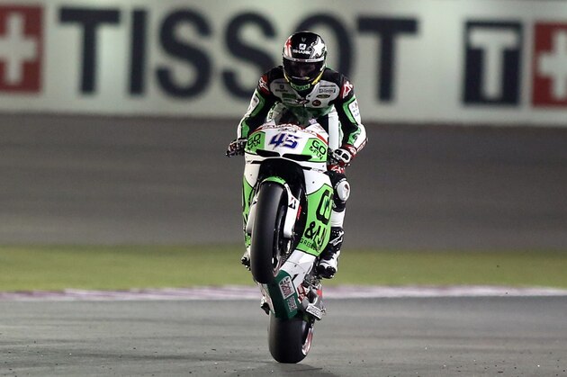 GO and FUN Honda MotoGP rider Scott Redding of Britain performs a wheelie at the Losail International Circuit during a free practice in Doha, Qatar, Friday, March 21, 2014. (AP Photo/Osama Faisal)