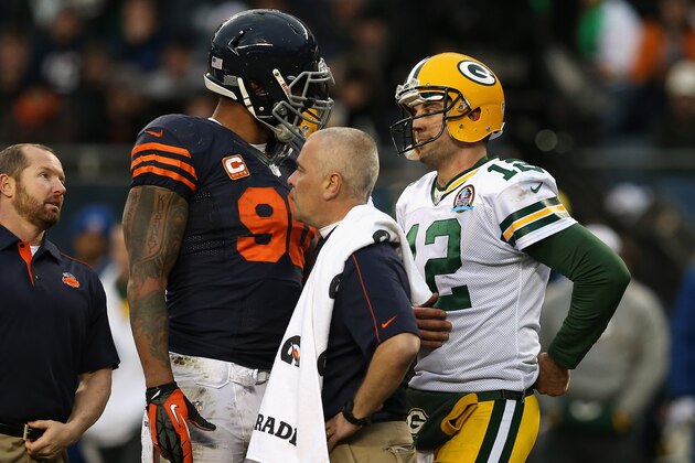 CHICAGO, IL - DECEMBER 16: Aaron Rodgers #12 of the Green Bay Packers talks with Julius Peppers #90 of the Chicago Bears after Peppers was flagged for roughing Rodgers at Soldier Field on December 16, 2012 in Chicago, Illinois. The Packers defeated the Bears 21-13.  (Photo by Jonathan Daniel/Getty Images)