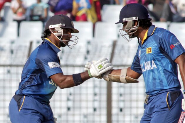 Sri Lanka's Kumar Sangakkara, right, congratulates teammate Kusal Perera for scoring fifty runs during the ICC Twenty20 Cricket World Cup match against South Africa in Chittagong, Bangladesh, Saturday, March 22, 2014. (AP Photo/Bikas Das)