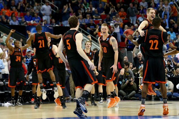 RALEIGH, NC - MARCH 21:  Bud Thomas #5, Ike Nwamu #10 Darious Moten #22 of the Mercer Bears celebrate after defeating the Duke Blue Devils 78-71 during the Second Round of the 2014 NCAA Basketball Tournament at PNC Arena on March 21, 2014 in Raleigh, North Carolina.  (Photo by Streeter Lecka/Getty Images)