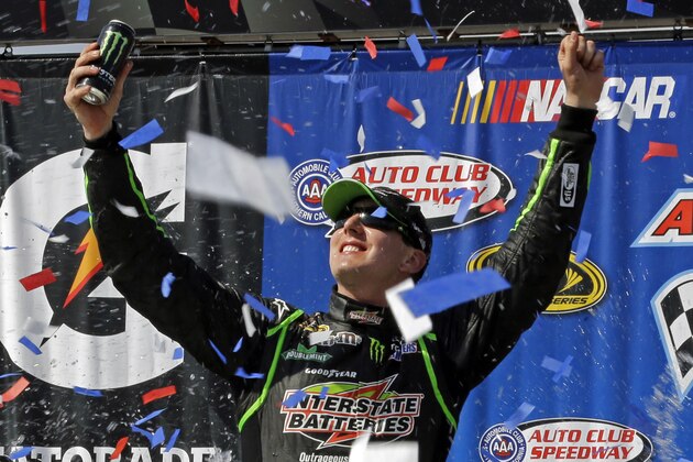 Kyle Busch celebrates his win in the NASCAR Sprint Cup Series auto race in Fontana, Calif., Sunday, March 24, 2013. (AP Photo/Reed Saxon)