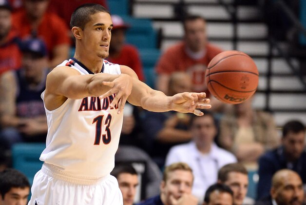 LAS VEGAS, NV - MARCH 13:  Nick Johnson #13 of the Arizona Wildcats passes the ball against the Utah Utes during a quarterfinal game of the Pac-12 Basketball Tournament at the MGM Grand Garden Arena on March 13, 2014 in Las Vegas, Nevada. Arizona won 71-39.  (Photo by Ethan Miller/Getty Images)