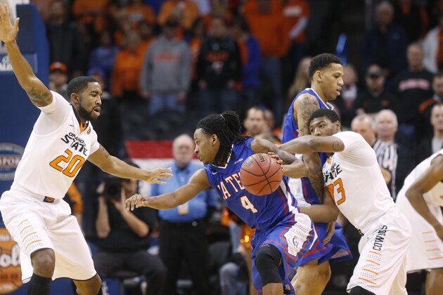 Louisiana Tech guard Kenneth Smith (4) drives between Oklahoma State post Michael Cobbins (20) and guard Marcus Smart (33) during the first half of an NCAA college basketball game in the All College Classic in Oklahoma City, Saturday, Dec. 14, 2013. (AP Photo/Sue Ogrocki)