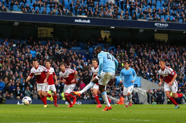 MANCHESTER, ENGLAND - MARCH 22:  Yaya Toure of Manchester City scores the opening goal from the  penalty spot during the Barclays Premier League match between Manchester City and Fulham at Etihad Stadium on March 22, 2014 in Manchester, England.  (Photo by Jan Kruger/Getty Images)