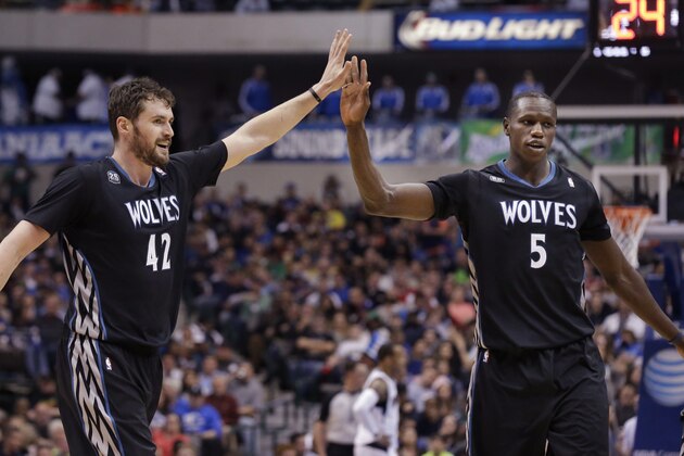 Minnesota Timberwolves forward Kevin Love (42) celebrates with teammate Gorgui Dieng (5) during the second half an NBA basketball game against the Dallas Mavericks Wednesday, March 19, 2014, in Dallas. The Timberwolves won in overtime 123-122. (AP Photo/LM Otero)